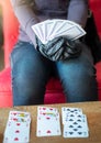 Young woman playing  cards alone at home wearing medical gloves,solitare ,while confined at home Royalty Free Stock Photo