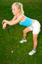 Young woman playing golf Royalty Free Stock Photo