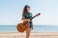 Young woman playing guitar on the beach Royalty Free Stock Photo