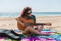 Young woman playing guitar on the beach Royalty Free Stock Photo