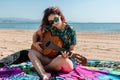 Young woman playing guitar on the beach Royalty Free Stock Photo