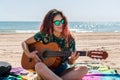 Young woman playing guitar on the beach Royalty Free Stock Photo
