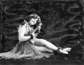 Young woman playing guitar in a Hawaiian grass skirt Royalty Free Stock Photo