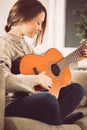 Young woman playing guitar at home Royalty Free Stock Photo