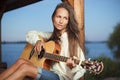 Young woman playing guitar outdoor on sunset Royalty Free Stock Photo