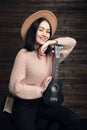 Young woman playing guitar and smiling. Music concept. Home atmosphere on background. Royalty Free Stock Photo