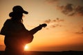 young woman playing guitar at sunset Royalty Free Stock Photo