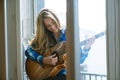 Young woman playing guitar on window Royalty Free Stock Photo