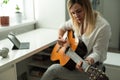 Young woman playing her guitar at home. High quality photo Royalty Free Stock Photo