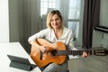 Young woman playing her guitar at home. High quality photo Royalty Free Stock Photo