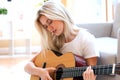 Young woman playing her guitar Royalty Free Stock Photo