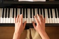 Young woman playing piano, above view. Music lesson