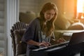 A young woman playing the piano.Close-up of a young beautiful blonde girl with reddish - brown hair playing the piano