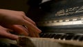 A young woman playing piano closeup. Piano hands pianist playing Musical instruments details with player hand closeup