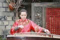 Young woman playing the pipa in kuanzhai alley , chengdu, china Royalty Free Stock Photo