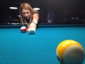 Young woman playing pool