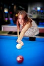 Young woman playing pool game in pub Royalty Free Stock Photo