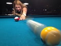 Young woman playing pool