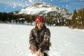 A young woman playing snow in the mountain. Outdoor activity during winter season and happy moment Royalty Free Stock Photo