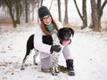 Young woman playing snow winter outdoors hugging cute adopted blind setter dog. Kindness and humanity concept. Royalty Free Stock Photo