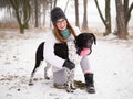 Young woman playing snow winter outdoors hugging cute adopted blind setter dog. Kindness and humanity concept. Royalty Free Stock Photo