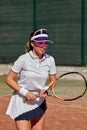 Young woman playing tennis on court during competition, portrait of female tennis player Royalty Free Stock Photo