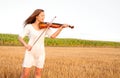 Young woman playing violin outdoors Royalty Free Stock Photo