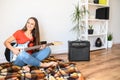 Young woman plays electric guitar at home Royalty Free Stock Photo