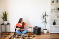 Young woman plays electric guitar at home Royalty Free Stock Photo