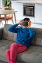 Young woman plays a game in virtual reality in 3D cyberspace simulation headset, futuristic gaming