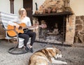 A young woman plays the guitar in a cozy atmosphere Royalty Free Stock Photo