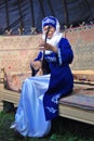 Young woman plays musical instrument. Sabantui celebration in Moscow