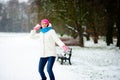 Young woman plays with someone in snowballs.