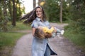 Young woman plays with toddler girl in yellow in park Royalty Free Stock Photo