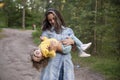 Young woman plays with toddler girl in yellow in park Royalty Free Stock Photo