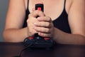 Young woman plays video game with a retro joystick