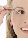 Young Woman plucking Eyebrow Royalty Free Stock Photo