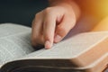 A young woman pointing out the verses of the Scriptures that are true to life. while reading the bible In the morning Royalty Free Stock Photo