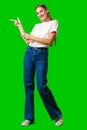 Young Woman Pointing at Something against green background