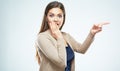 Young woman points finger to the side, covering mouth in surpr Royalty Free Stock Photo