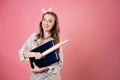 young woman in a polka dot apron is looking for a recipe for a dish on the Internet, learning how to cook.