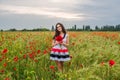 Young woman in poppy field
