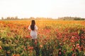 Young woman in poppy field