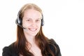 Young woman portrait in call center of an advertiser with telephone headset smiling and pleasant