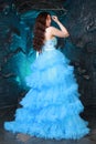 Young Woman Portrait in Evening Blue Long Dress on studio background Royalty Free Stock Photo