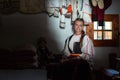 Young woman portrait inside traditional home with Romanian traditional costume