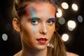 Young woman portrait, multicolor face painting. Model with make up. Girl with art paint