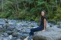 Young Woman Poses Along the Banks of a River