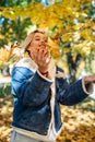 Young woman posign at autumn park outdoor