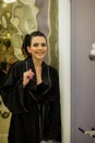 Young woman posing in black silk bathrobe. sexy housewife concept. Girl in a black bathrobe indoors. Beauty saloon Royalty Free Stock Photo